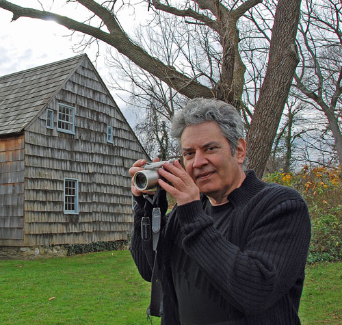 Joe Giaquinto with a digital camera in hand at the Brewster House in Setauket, New York.